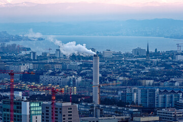 Fototapeta premium Aerial view over City of Zürich on a beautiful sunny autumn evening with lake and Swiss Alps in the background. Photo taken December 6th, 2022, Zurich, Switzerland.