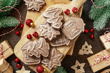 Christmas gingerbread cakes among the festive decor. New Year's traditional pastries top view