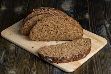 Sliced black rye bread on a board