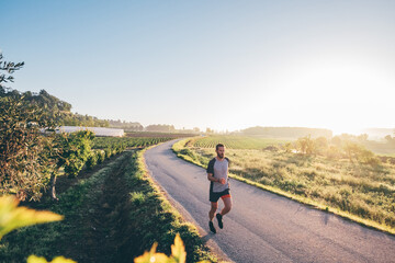 Man running in the countryside at sunrise