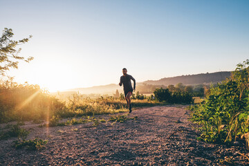 Man running in the countryside at sunrise