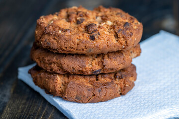 Delicious cookies with pieces of chocolate on the table