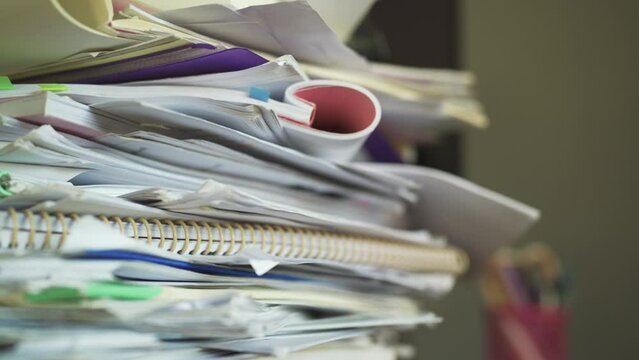 A Pile Of Paperwork On A Table