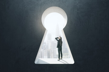 Abstract image of thinking businesswoman standing in keyhole opening and looking into the distance...