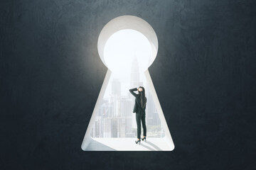 Abstract image of thinking businesswoman standing in keyhole opening and looking into the distance on blurry city background. Vision, future and think concept.