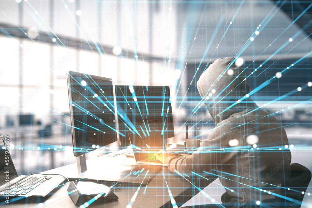 Poster hacker using laptop at desktop with creative linear matrix hologram on blurry office interior background. Metaverse, hacking, data theft, vr and futuristic technology concept. Double exposure.