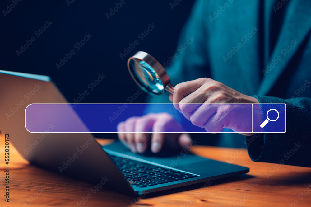 Fototapete Businessman use magnifying glass Search On Virtual Screen Data Search Technology Search Engine Optimization. Man use computer to Searching for information. Using Search Console for data, info.