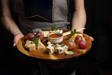 Cheese plate: Camembert, Parmesan, blue cheese with  nuts, honey and grapes