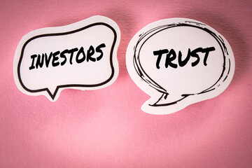 Investors trust concept. Two speech bubbles with text on a pink background