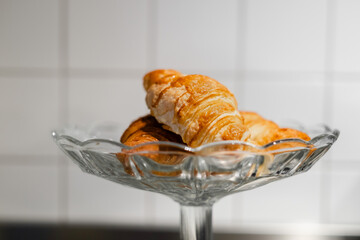 croissants are in a crystal dessert vase in the kitchen. homemade cakes. selective focus