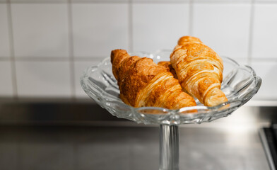 croissants are in a crystal dessert vase in the kitchen. homemade cakes. selective focus