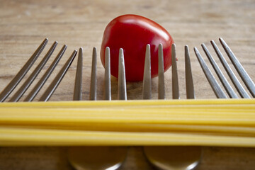 composition of spaghetti forks and cherry tomato