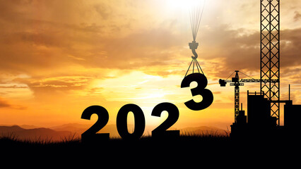 silhouette of construction worker in building new year 2023 with sky background at sunset Countdown...