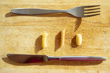raw pasta and cutlery