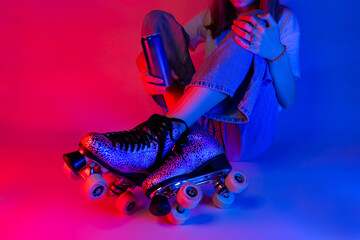 Roller skater holding a soda drink in a can while skating break. Sports - pink and blue pop art style poster.