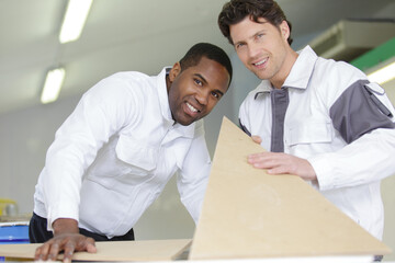 decorating team holding wooden templates