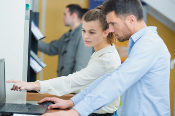 Fototapeta premium young female in business school office classroom working with teacher