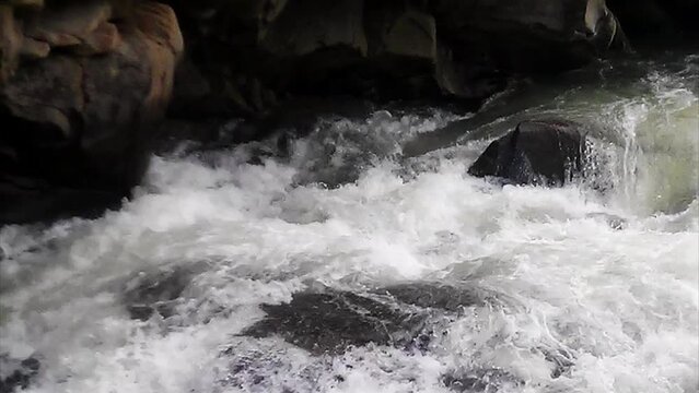 Stormy mountain river. Rapid flow of water.