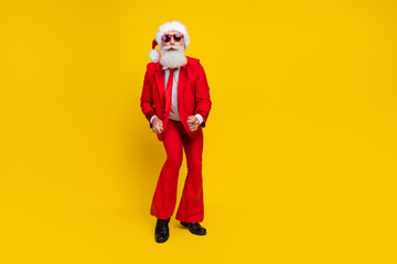 Full length photo of handsome excited claus wear red tux costume having fun disco dancing empty space isolated yellow color background