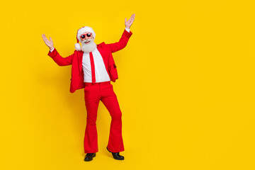 Full size photo of positive excited funky granddad raise hands enjoy event empty space isolated on yellow color background
