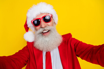 Photo of charming positive claus wear red tux costume tux smiling tacking video isolated yellow...