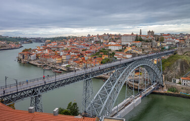 Fototapeta na wymiar Old town skyline and Dom Luis bridge on the Douro River. Portugal.