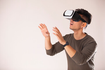 Portrait of an excited young man experiencing virtual reality eyeglasses headset 