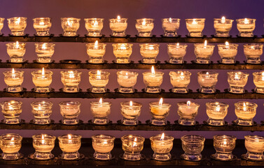 rows of candles, close-up. Prayers, losses and wishes.
