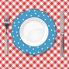 Dark blue plate with figured edges and polka dot pattern placed on red check classic seamless tablecloth. Closeup view from above. - 552012915