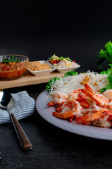 Close up of steam shrimp and pork belly with fresh vegetable on table.
