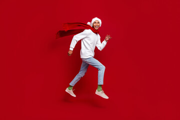 Fototapeta na wymiar Full length profile photo of crazy active person running jumping isolated on red color background