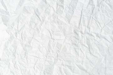 Wrinkled or crumpled white stencil paper or tissue after use with large copy space is used for background texture.