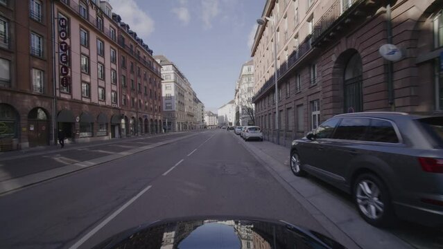 POV Driving in the city center of the french town Straßbourg. Strasbourg is an iconic place in France with landmarks like the Strassburg Cathedral. Filmed by a cinema camera in early spring from a car