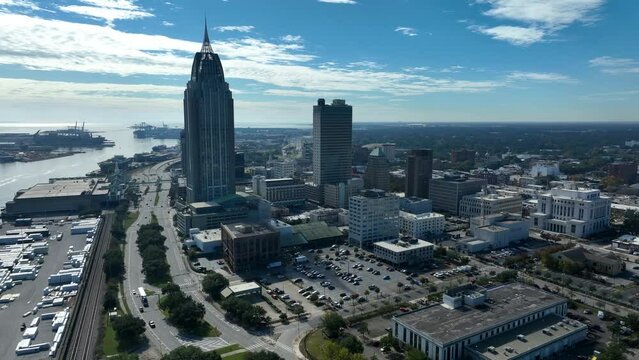 Downtown Mobile Alabama on sunny day. Gulf of Mexico and shipyard. Aerial view.