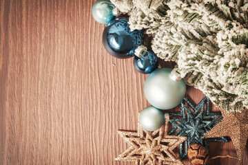 Christmas composition with snowy tree branch with toy balls and stars and cones. Toned New Year's decorative mockup with copy space