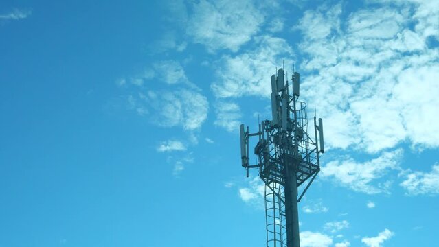 Closeup Cellular Communication Station, Cell Tower on a Sunny Day Blue Sky White Clouds Time Lapse.