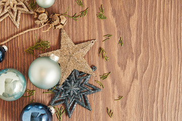 New Year decor with blue toy balls, stars and snowflakes and cones. Horizontal festive Christmas mockup with copy space