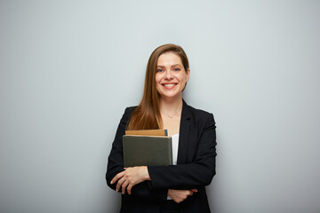 Fototapeta premium Smiling woman teacher or student holding book. Isolated portrait with copy space.