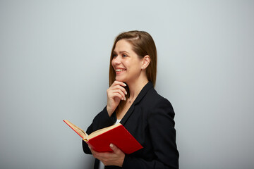 Smiling woman teacher or student holding open red book. Isolated portrait with copy space.