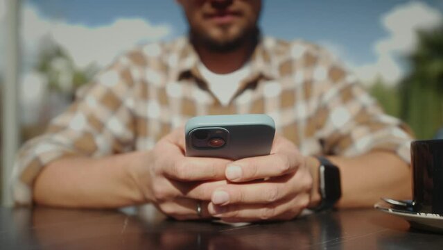 Close up of male hands holding smartphone. Happy mixed race man enjoy online chat, internet purchase, browse web, download new cool freeware application.