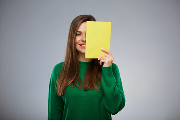 Woman teacher or student covered her face with yellow book. Isolated advertising portrait. - 552021334