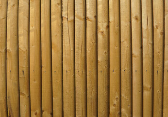 Vertical wooden brown fence texture for backgrounds. It was taken in a UK house garden and it can be used as a pattern. © Julien