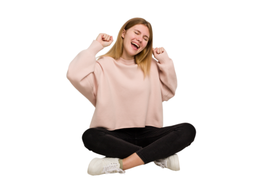 Young caucasian woman sitting on the floor cutout isolated