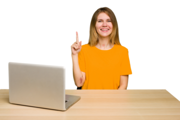 Young caucasian woman in a workplace working with a laptop isolated showing number one with finger.