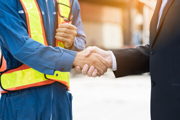 Hands of supervisor successful of their work and handshake at container yard site. Two male...