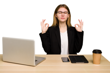 Young business caucasian woman working on her workplace cutout isolated relaxes after hard working day, she is performing yoga.