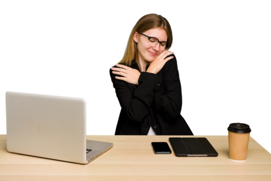 Young business caucasian woman working on her workplace cutout isolated hugs, smiling carefree and happy.
