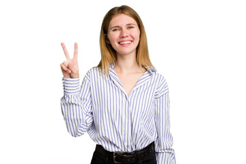 Young caucasian woman isolated joyful and carefree showing a peace symbol with fingers.