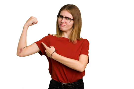 Young caucasian woman isolated showing strength gesture with arms, symbol of feminine power