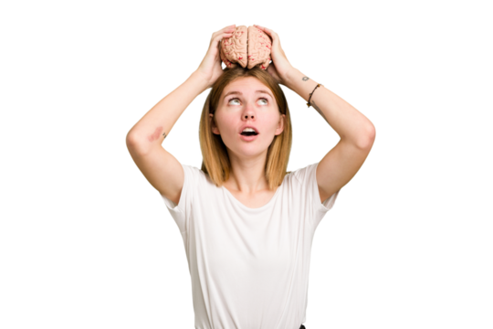 Young caucasian woman holding a brain isolated